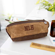 monogrammed waxed canvas dopp kit on bathroom counter
