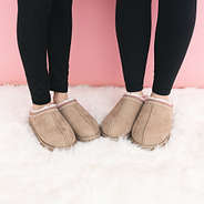 kids tan pink moccasins on fur