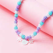 girls snowflake necklace on pink background