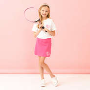 white short sleeve shirt with skort and tennis racket