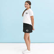 girl wearing monogrammed black skort with white t shirt