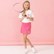 girl with hot pink monogrammed skort playing tennis