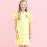 girl wearing monogrammed girls flutter sleeve dress in soft yellow