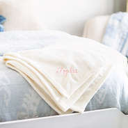 ivory kids plush blanket on bed