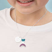 girl wearing monogrammed mermaid necklace