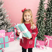 crimson kids sequin bow sweatshirt on girl with present