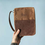 man holding bible carrier in brown
