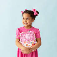 girl holding pink bible carrier