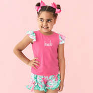 girl wearing monogrammed ruffle short set in floral burst