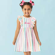 girl wearing monogrammed girls multi striped ruffle knit dress up close