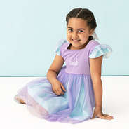 girl sitting in personalized blue and purple twirl dress