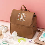 monogrammed diaper backpack purse with girls toys and accessories