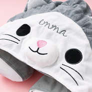 close up of monogrammed kids hooded travel neck pillow