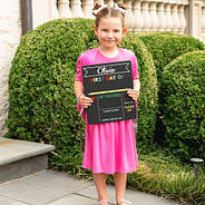 elle holding back to school chalkboard
