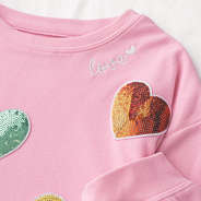 close up of kids sequin heart sweatshirt