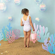 Back of Girl wearing ruffle bathing suit in mermaid