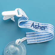 close up of personalized paci clip in navy seersucker