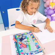 girl drawing next to personalized binder pouch in watercolor cheetah