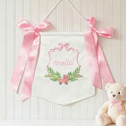 pink new baby banner on wall