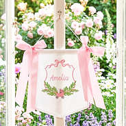 pink new baby banner on window