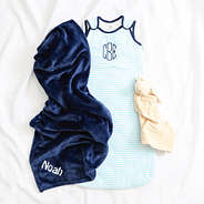 navy blue baby blanket flatlay with baby wearable blanket