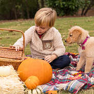 little boy in sherpa pullover with puppy