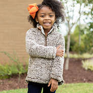 toddler girl wearing heathered sherpa pullover and bow