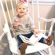 little girl in gray monogrammed sweater