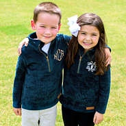 friends wearing matching teal corded pullovers