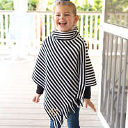 youth girl wearing black and white fringe poncho