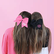 sisters wearing pink and black hair bows