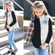 cute girl in monogrammed vest and black top and ballet slippers