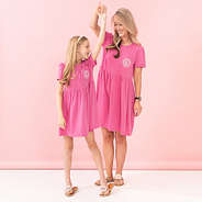 mom and girl dancing in t shirt dress in hot pink
