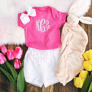 cute baby onesie with flowers and white shorts