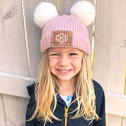 pink pom pom beanie on little girl