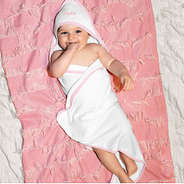 baby girl wearing pink hooded towel