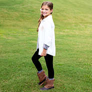 side shot of girl wearing white button down tunic