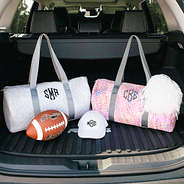 kids duffel bags in the back of a car trunk