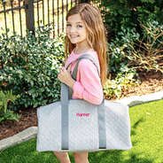 girls gray duffel bag on shoulder with name monogram