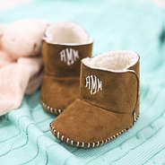 brown baby booties on blanket