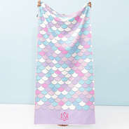 girl holding monogrammed kids beach towel in mint mermaid