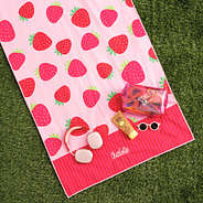 personalized beach towel in strawberries on grass