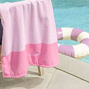 personalized kids beach towel in pink mini stripes on pool chair