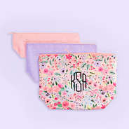 monogrammed kids toiletry bag in coral floral purple background