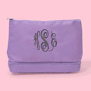monogrammed kids toiletry bag in lilac pink background
