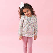 toddler in ruffle set